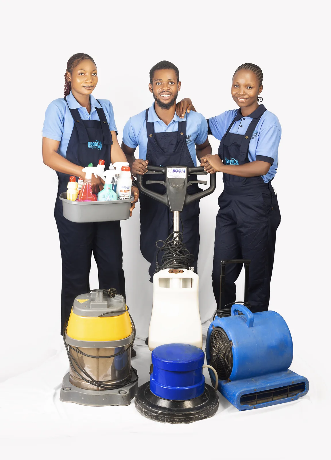 Three BOOM Cleaning team members with cleaning machines and supplies